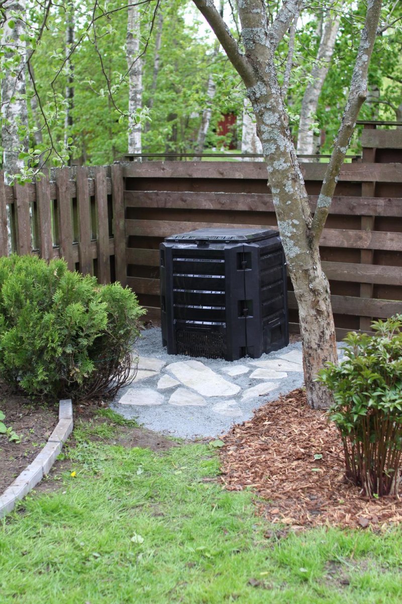 Backyard corner with compost bin