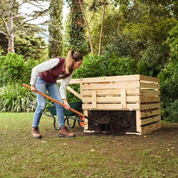 Wheelbarrow beside compost bin path
