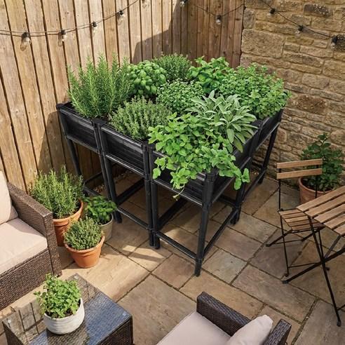 Compact raised herb planter on a small sunny patio