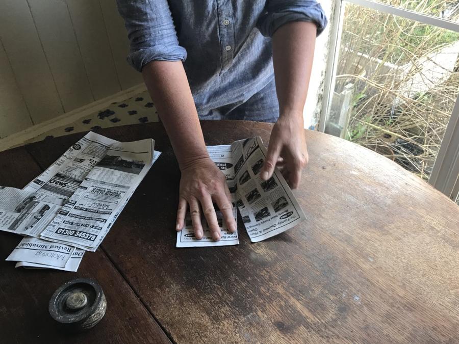 Folding newspaper into plant containers