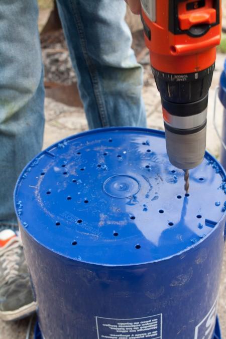 Drilling drainage holes in bucket