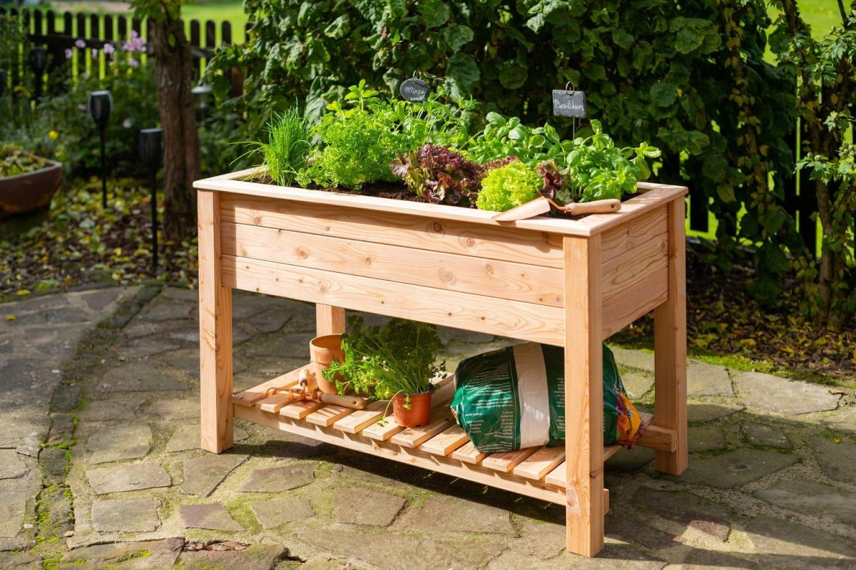 Compact wooden raised garden bed filled with fresh lettuce and vegetables